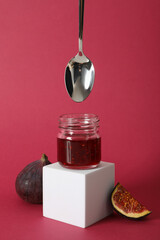 Sticker - Fig jam in jar, spoon and piece of fig on pink background