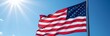 © Arma - American flag waving against a clear blue sky, symbolizing patriotism, pride, seasonal relevance for July 4th, copy space for texts.