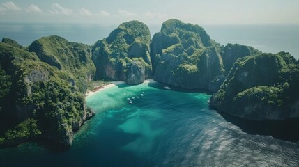 Aerial view Andaman Sea in a bay with a beach surrounded by green mountains at Phi Phi island, Maya Bay, Krabi, Thailand