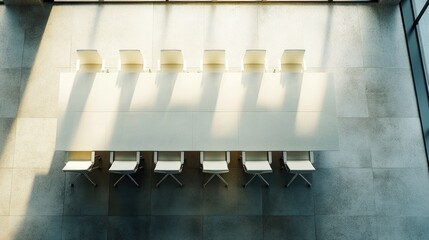 Poster - Aerial view of a conference room with a well-arranged table and empty chairs, ideal for overlaying your own text