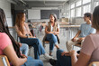 © EFStock - Teenager students listening and talking to friendly mature female teacher - Group discussion in High School Education