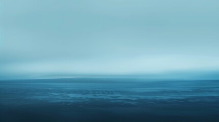 Wall Mural - A blue ocean with a cloudy sky in the background