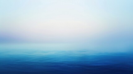 Wall Mural - A calm blue ocean with a hazy sky in the background