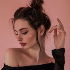 Wall Mural - A beautiful young woman gesturing downward to her right, isolated on a dusky rose background. 