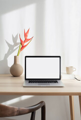 Laptop computer with empty blank mockup screen over white modern living room design. Advertisement, e-learning, shopping online, web site design, technology concept