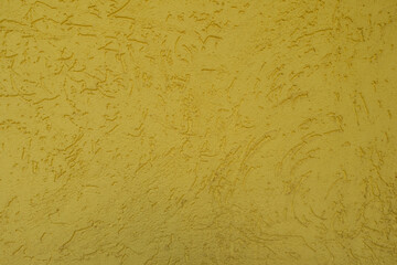 Texture of yellow wall with stucco worm finish