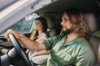 © SHOTPRIME STUDIO - Man driving a car with a woman in the passenger seat, both focused ahead, showcasing a relaxed and modern interior setting
