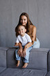 © F8  \ Suport Ukraine - Son and mom sitting on couch at home and embracing celebrating mothers day