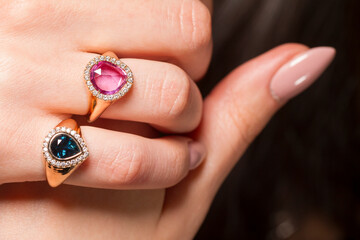 Macro shot of a jewel ring on a female hand.