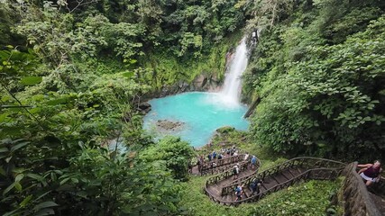 Wall Mural - Tourists visiting the Rio Celeste Waterfall in Tenorio Volcano National Park of Costa Rica