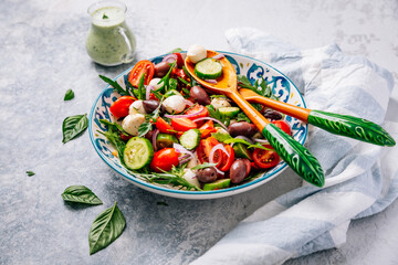 Fresh vegetarian salad with dried and fresh tomatoes, mozzarella and arugula