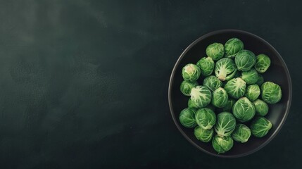 Canvas Print - A bowl of fresh, green Brussels sprouts against a dark background, highlighting their vibrant color and promoting healthy, natural eating.