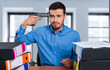 © Minerva Studio - Stressed businessman with a gun to his head at office desk