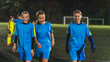 © PoppyPix - teenage girls football team having a break during evening practice, blue uniforms, children active lifestyle. High quality photo