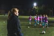 © PoppyPix - a female coach talking to her football player girls and making them ready for practice. High quality photo