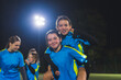 © PoppyPix - cheerful football girls in blue uniforms posing together, medium shot. High quality photo