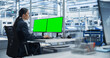 © Gorodenkoff - Female Robotics Technician Working on Desktop Computer with Green Screen Chromakey Mock Up Display in a Factory Office. Technological Research, Development Facility with Autonomous Assembly Line
