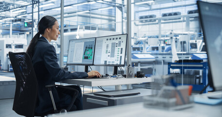 Fototapete - Asian Industrial Engineer Doing Creative Work on Computer in Office. Intelligent Female Creating an Innovative Motherboard with Powerful Microchips for Artificial Intelligence Systems