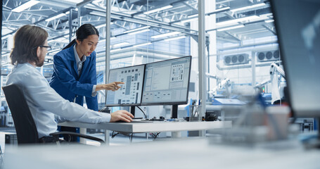 Fototapete - Experienced Male Engineer and Asian Chief Technology Officer Working at a Modern Industrial Factory, Using Computer and Discussing Production of Modern Electronics for Artificial Intelligence Machines