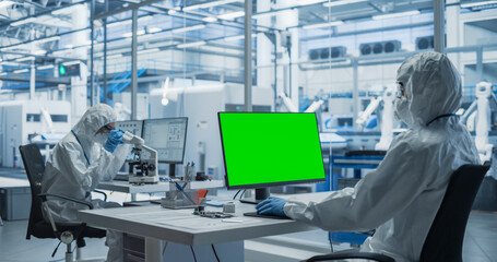 Aufkleber - Two Laboratory Workers in Protective Coveralls Developing a Central Processing Unit. PCB Designer Working on a Computer With Green Screen Chromakey On Display, While Colleague is Using a Microscope