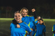 © PoppyPix - medium shot of young football player girls being on a positive mood before match and showing power. High quality photo