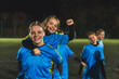 © PoppyPix - cute teenage girls in blue uniforms having fun together at the late evening practice, soccer concept. High quality photo