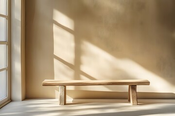 Wall Mural - A minimalist wooden bench against a beige wall with delicate shadows of leaves and branches, creates a serene atmosphere for product photography