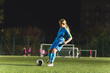 © PoppyPix - Kids soccer football - young little girl is shooting ball at soccer field. High quality photo