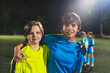 © PoppyPix - medium shot of two football teammates at the late evening practice, team sport concept. High quality photo