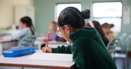 Poster - Child, student and writing in classroom for learning, education and problem solving by desk with knowledge. Girl, study and exam in elementary school with pencil for development, growth and project