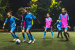 © PoppyPix - little soccer player girls performing an action play on a soccer stadium. Girls in uniforms playing soccer . High quality photo