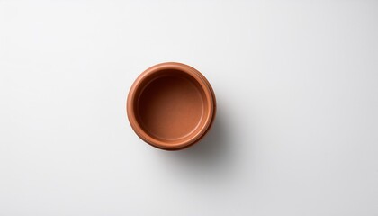 Wall Mural - overhead shot of tiny pot on white backdrop