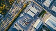 © Media Srock - Aerial view of an industrial area with buildings, cargo trucks, and a highway, showcasing a bustling urban environment and logis
