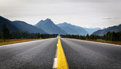 an asphalt road with a yellow dividing strip leads into the distance mountain landscape in the backg