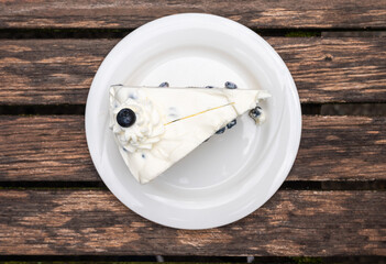 Wall Mural - Cheescake with blueberry decoration on a worn wooden table, Fischerhude, Lower Saxony, Germany