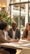 © liliyabatyrova - A cheerful group of diverse professionals engaged in a lively discussion while sitting around a table, showcasing teamwork and creativity