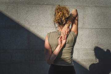 One adult caucasian woman stretch yoga practice in summer day outdoor