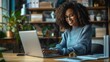 © IQRAMULSHANTO - African American woman smiling and typing on a laptop at a desk with a modern office background.