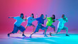 © master1305 - Five kids strike dynamic hip hop poses with intense focus and style against gradient pink purple background in neon light. Concept of modern dance styles, youth culture, active lifestyle