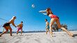 © master1305 - Young people, friends, men and women competing in a high-energy game of beach volleyball, under clear blue sky. Concept of sport, summer activity, leisure games, friendship