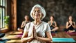 © Ruslan Gilmanshin - In spacious bright yoga studio, elderly retired woman is engaged in physical education. At class, lady performs half-lotus pose
