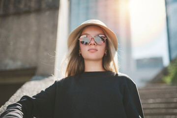 young girl standing at city street. Outside portrait of joyful beautiful teen over urban background.