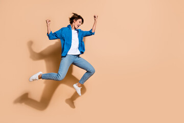 Aufkleber - Full body length size photo of young overjoyed business woman in blue shirt fists up winning lottery isolated on beige color background