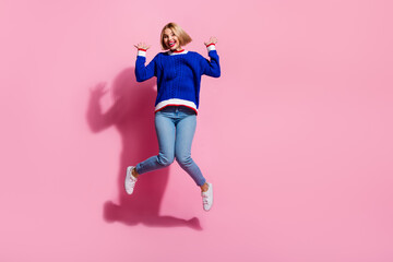 Poster - Full body size photo of active happy woman jumping having fun entertainment raised palms up at party isolated on pink color background