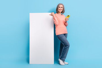 Poster - Full length photo banner advertisement electronics shop website nomad panel directing finger senior woman promoter isolated on blue color background