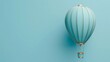 © IMRAN - Blue and gold flying balloon on light blue background