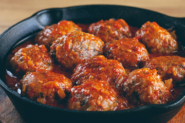 minced meat meatballs, in tomato sauce, in a cast-iron pan, homemade, no people,