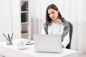 Wall Mural - Teenager working with laptop at home. Remote job