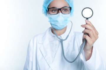 Doctor holding stethoscope on white background, selective focus