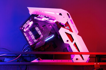 Poster - Professional gaming computer with neon backlight with headset in the computer club for gamers.